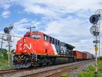 <b>Factory fresh.</b> Brand new ET44AC CN 3069 is only a few weeks out of the factory as it leads CN 377 past some nice searchlight signals on CN's Kingston Sub in Beaconsfield. Operating mid-train is ET44AC CN 3055, only a few months older than the leader.