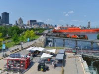 <b>Nose to nose GP9's.</b> GP9's CN 7075 & CN 7256 are lashed up nose to nose as they cross the Lachine Canal with a short train out of the Port of Montreal on a sunny afternoon.