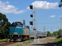 <b>Splitting the endangered dwarf signals.</b> VIA 635 is seen splitting a set of old dwarf signals that will soon be replaced by the new signals that are currently turned away from the track on CN's Montreal sub in the St-Henri neighbourhood of Montreal. VIA 6413 is leading this train that goes to Ottawa with only one intermediate stop at Dorval. 