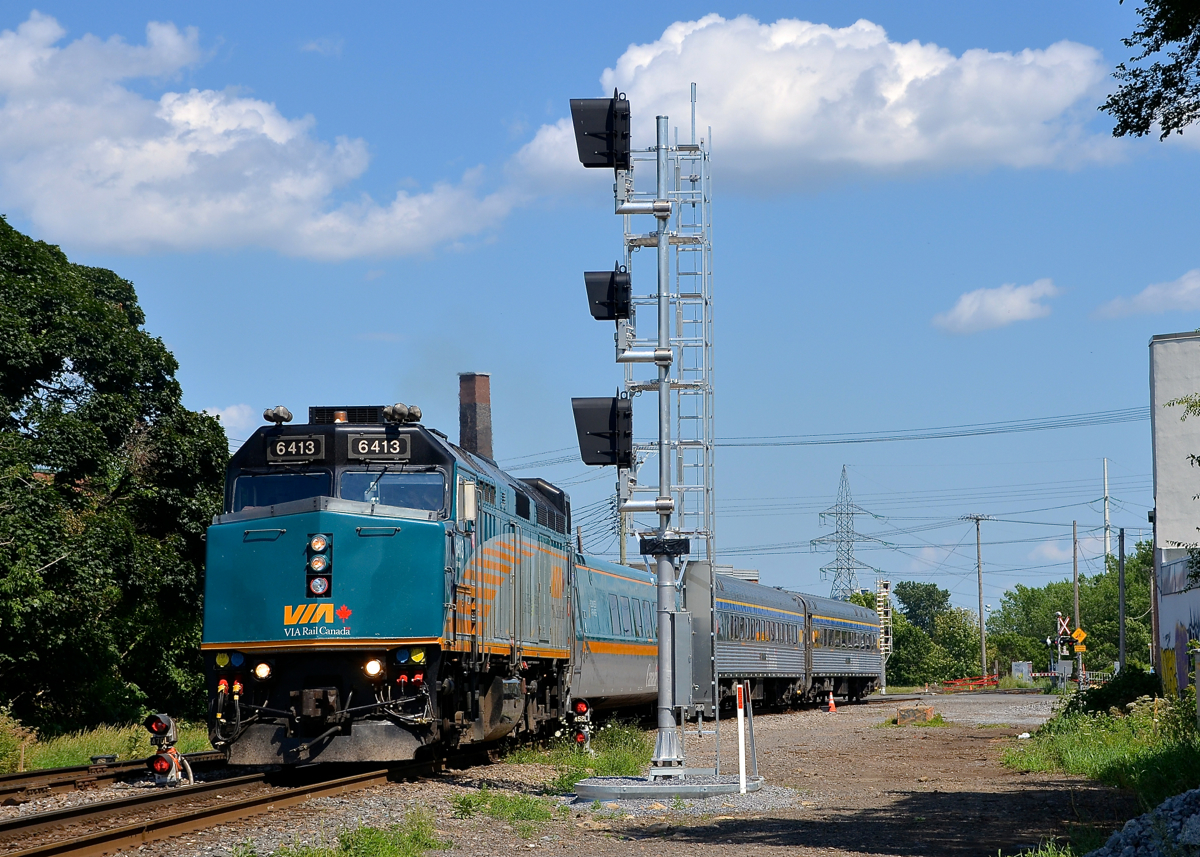 Splitting the endangered dwarf signals. VIA 635 is seen splitting a set of old dwarf signals that will soon be replaced by the new signals that are currently turned away from the track on CN's Montreal sub in the St-Henri neighbourhood of Montreal. VIA 6413 is leading this train that goes to Ottawa with only one intermediate stop at Dorval.
