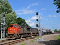 <b>Past the old and new signals.</b> CN X321 is passing a set of old dwarf signals that will soon be replaced by the new signals that are currently turned away from the track. Power on this train originating at Southwark yard on an as needed basis is CN 8815 and IC 1000.