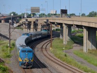 <b>Shoving on the rear of a well-powered passenger train.</b> VIA 633 for Ottawa is approaching Turcot West with VIA 907 bringing up the rear, along with VIA 6411 leading, and a second P42DC in the middle of the train. 