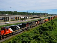 In a refreshing change from a sea of GEVO's, CN 2033, CN 5739 & CN 5790 lead a 566-axle long CN 149 through Montreal.