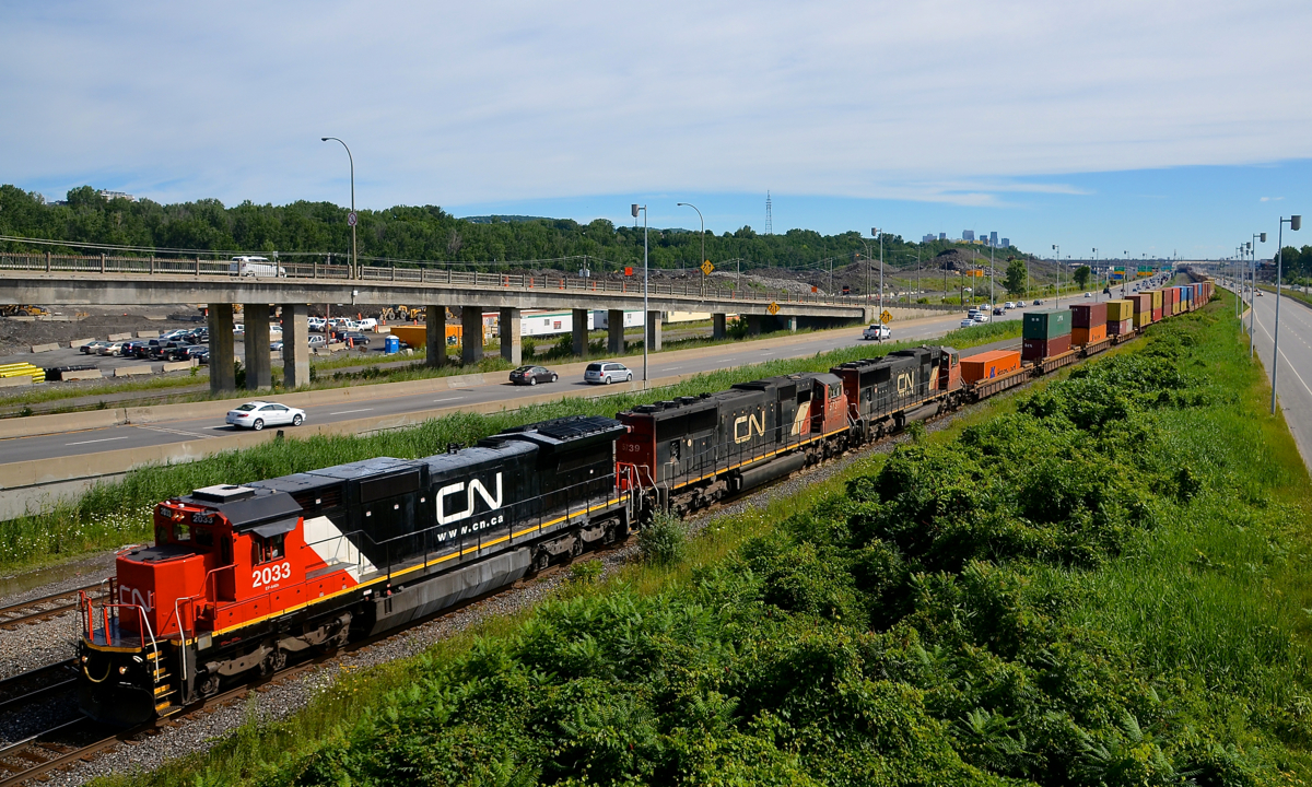 In a refreshing change from a sea of GEVO's, CN 2033, CN 5739 & CN 5790 lead a 566-axle long CN 149 through Montreal.