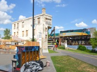 <b>A tower, a piano and a VIA Rail train.</b> VIA 635 is seen passing Wellington tower five minutes after leaving Central Station in Montreal with VIA 6449 leading. In the foreground is a piano, part of the city of Montreal's 'public piano' program.