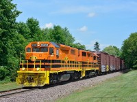 The westbound Quebec Gatineau freight on the Lachute sub approaches the town of Lachute on a sunny July afternoon.