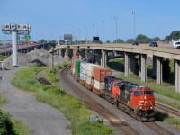 CN 2820 & CN 5654 lead CN 120 eastwards on CN's Montreal sub. A third unit (CN 2829) is operating mid-train.