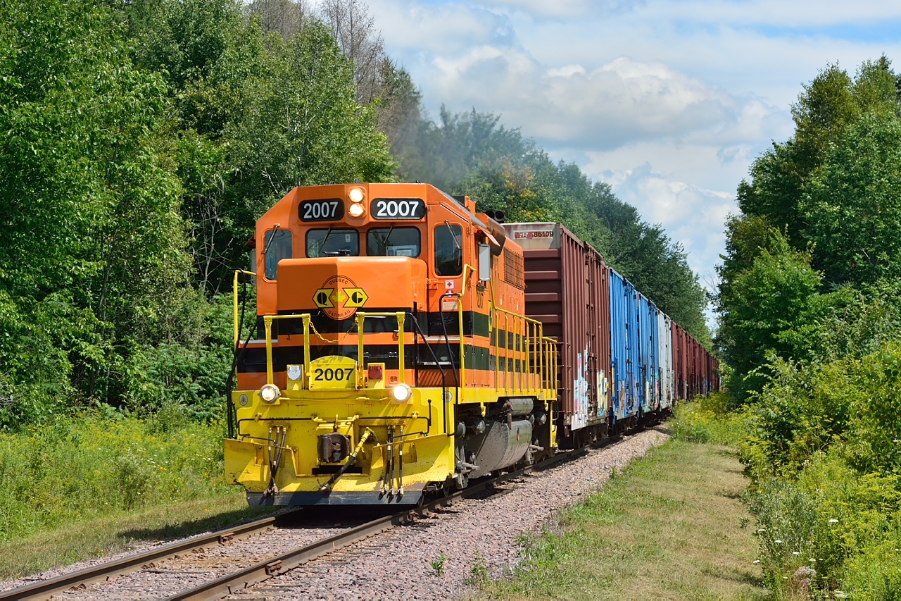 Pulling hard with twenty-six cars QG 2007 approaches Marelan, Quebec on a beautiful summer day.