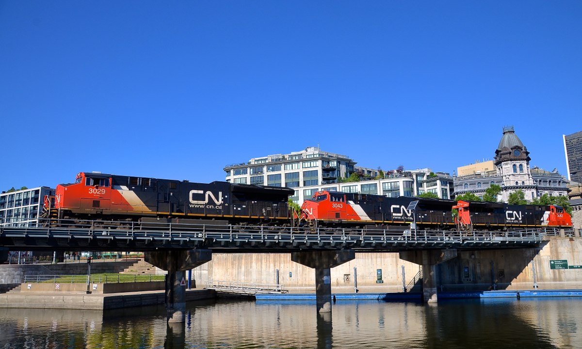 A trio of ET44AC's. A trio of ET44AC's (CN 3029, CN 3043 & CN 3063) lead CN 149 over the Lachine canal in the Port of Montreal.