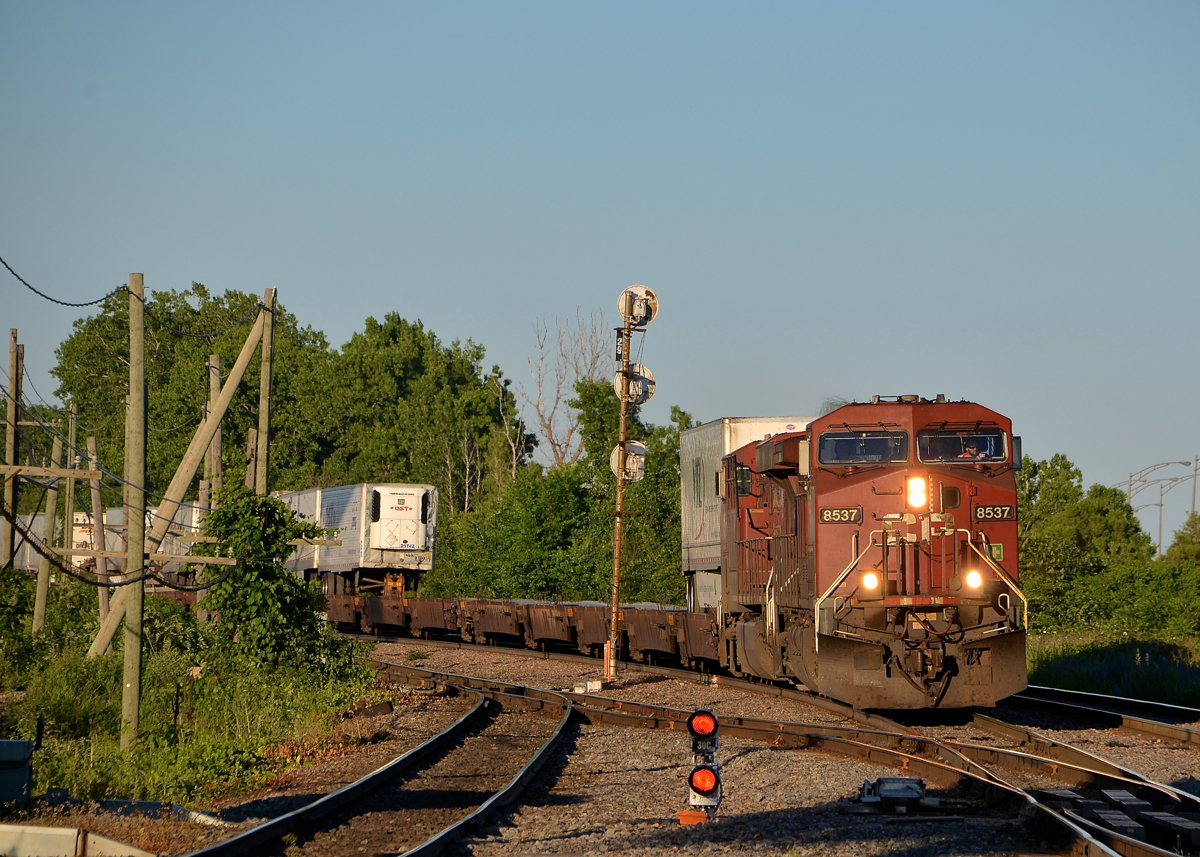 CP 133 around the corner. CP 8537 & CP 8714 lead CP 133 through Lachine on a sunny evening.