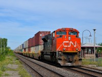 <b>In from the west coast on Canada Day.</b> On Canada Day, CN 106 is nearly finished its continentwide trek from Roberts Bank near Vancouver, BC as it approaches its terminus of Taschereau Yard in Montreal. Up front is CN 8958, with CN 2834 operating mid-train.