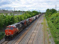 CN 3008 & CN 2887 lead CN 394 out of Taschereau Yard as it crosses over from the north to the south track. About half of the train will be set off at St-Hyacinthe, with the rest of the train destined for Richmond, Qc and interchange with the St. Lawrence and Atlantic Railroad.