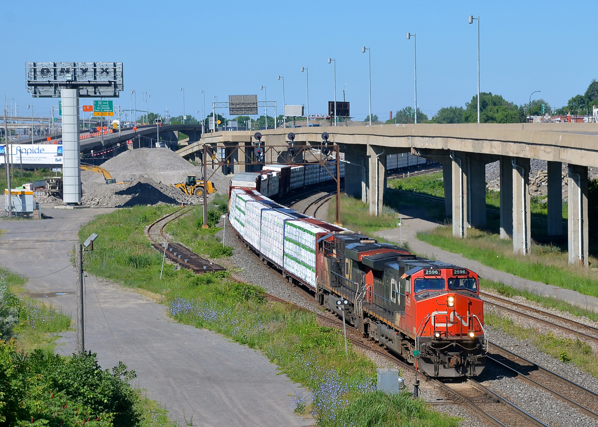 CN X324 has CN 2596 & CN 2286 for power and 48 cars in tow destined for St.. Albans, Vermont and interchange with the NECR as it heads east on CN's Montreal sub.