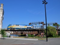 <b>Over the bike path on a sunny evening</b> A late VIA 64 is passing over the popular Lachine Canal bike path as it approaches the closed Wellington Tower on a sunny evening.