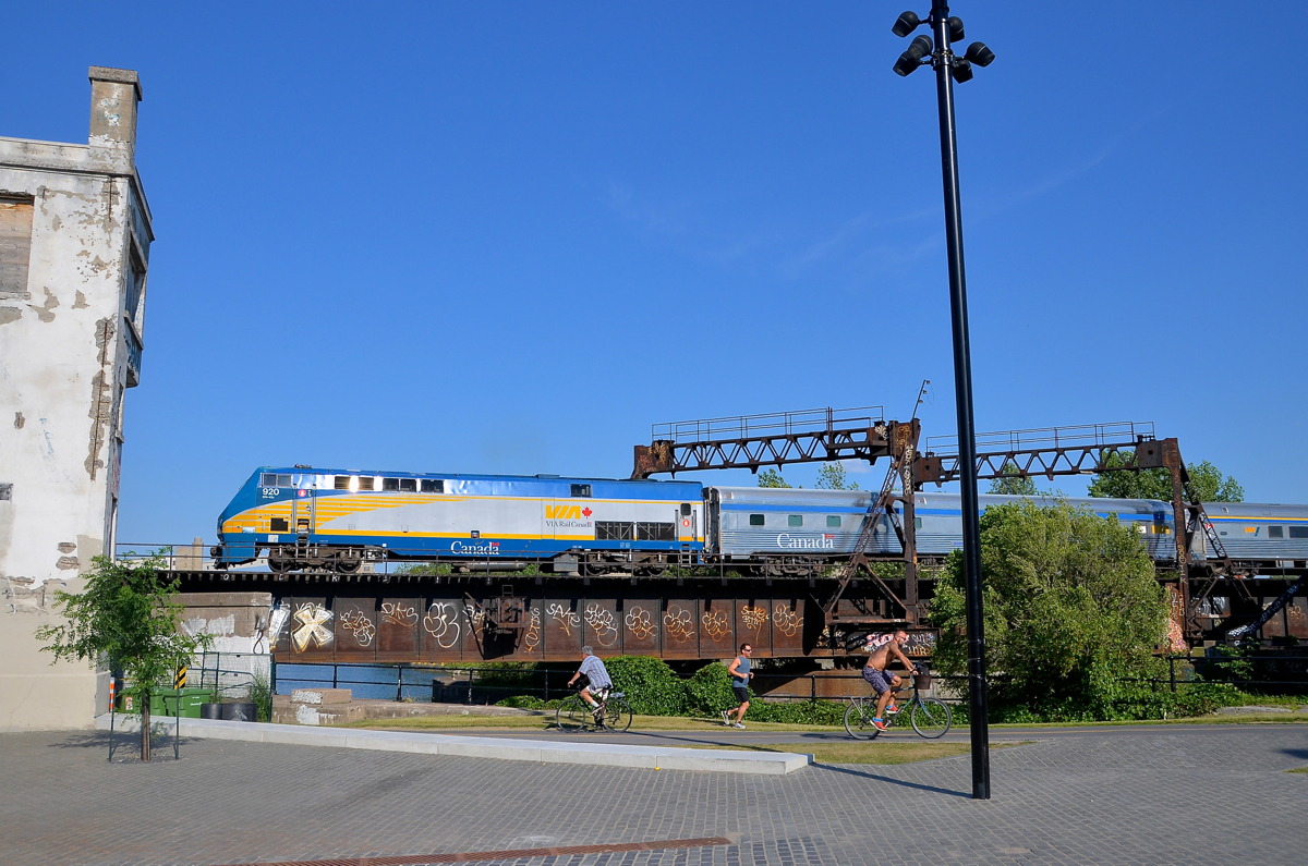 Over the bike path on a sunny evening A late VIA 64 is passing over the popular Lachine Canal bike path as it approaches the closed Wellington Tower on a sunny evening.