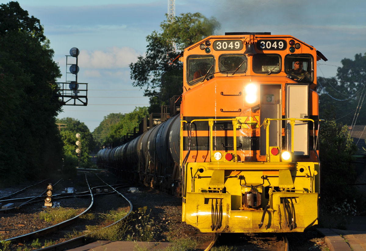 A few minutes after VIA 79 has cleared, 597 with RLHH 3049 and RLHH 3403 accelerates off the Hagersville Sub with 24 tank cars for interchange with CN in Paris
