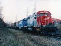 This so-so November afternoon actually started off as a quest to find #328, which was down in the Welland area. Upon success, and return, I did my shopping/snooping and heard #333 over the scanner being held at mile 2.8 Grimsby sub. It was late in the day and in November the sun sets early. I parked at Whirlpool and Stanley Av as I could see the train almost around the bend from the road. Walked in. Quite the surprise it had a Duluth, Winnipeg & Pacific on the lead. Rare thing in these parts. And only 10 of these SD40s on the roster to begin with. The light was so bad that I had to find an old board and use it for a monopod in order to get a shot of this train with the Mamiya 645. I have 400 ISO film and couldn't even get a reading. This is the result of "board-held" effort for 8 seconds set at 5.6 for some sharpness. Lost a bit of colour but at least I did not blur the shot while counting off the time.
DW&P was CN's connection to Duluth, MN from Fort Frances, ON. The road existence began between 1901-1908; it was originally the Duluth, Virginia & Rainy Lake. Taken over by CNoR (Canadian Northern) which in turn went bankrupt and was taken over by CN. This subsidiary line had its identity eliminated for the most part when CN began in 1994/95 to put all locos under one banner, which was 'CN North America'. However, the DWP for all intents and purposes still exists.
Quite the lashup this was: DWP 5909, CR 6657 and GT 5806. A real CN treat. 