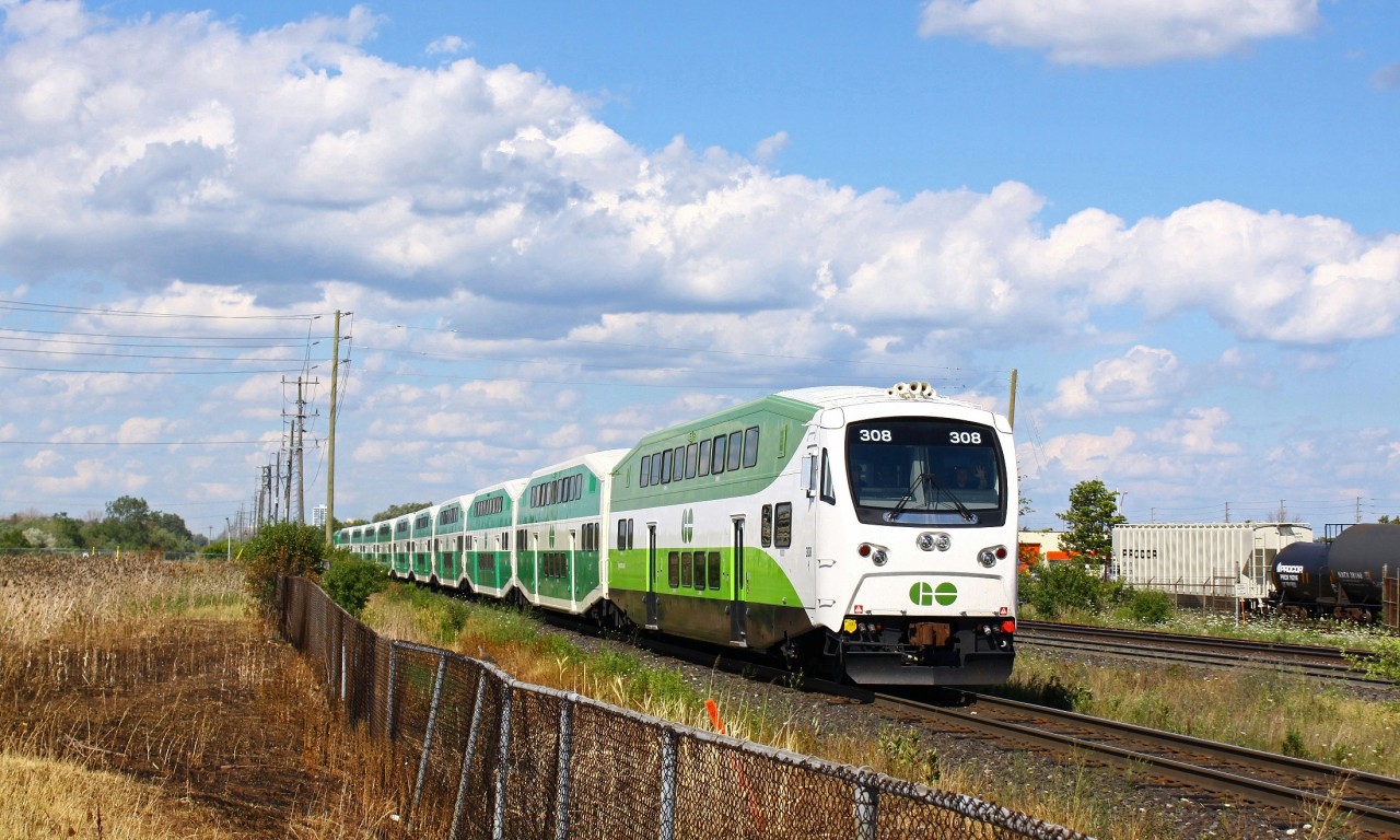 Westbound GOT 308 begins to lean into the curve around the platform at Bronte station. I didn’t notice until post-processing but the conductor gave me a friendly wave, a little different than the perplexed look I usually get from most GO crews while taking photos. One thing to note, in the bottom left you can see the scorched wild grass. In the previous week or two (or more, can’t remember specifically) the regular Oakville-Aldershot (CN 5 something, something) turn passed by the vacant field while throttling up, throwing sparks to the wind igniting the extremely dry grass (this was during heat wave). It was a pretty intense fire and went right up to the edge of the GO parking lot, and most likely would’ve damaged cars had the fire department not been there.