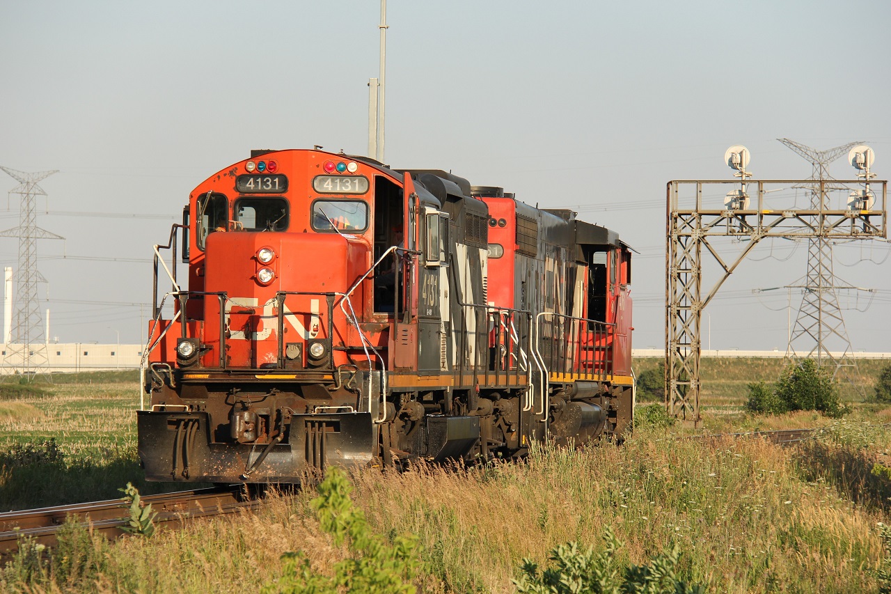 CN 551's crew has their doors open to try and catch a breeze on this hot summer evening. These CN GP9s are still soldiering on well into the 21st Century!
