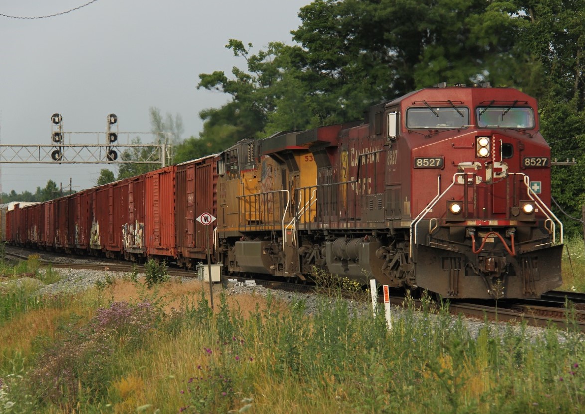 CP 8527 and UP 5360 lead an eastbound manifest at around 7:45 on the morning of July 13, 2016.