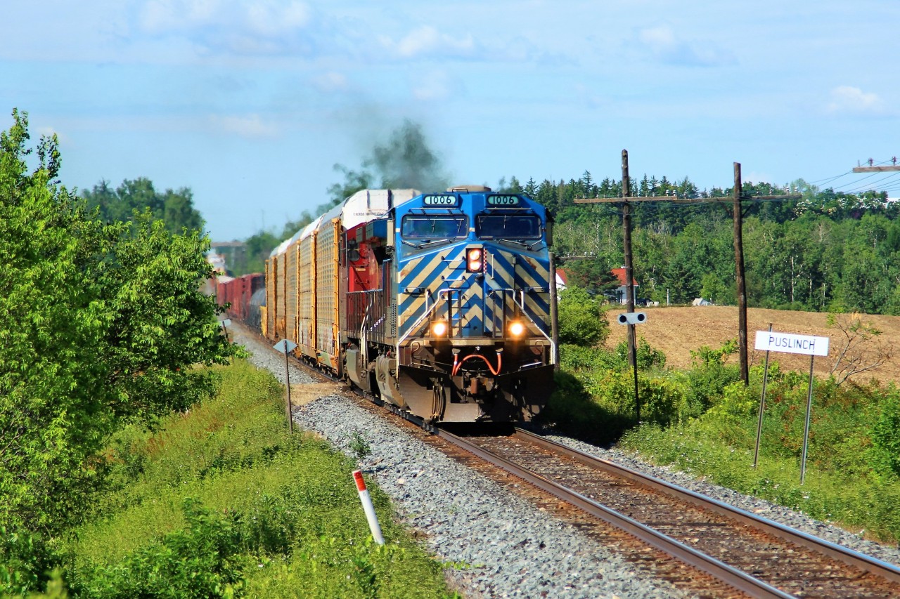 CEFX 1006 with CP 8517 for added power, leads a 9900 foot train up the grade to the Puslinch Marker board having just past MM44 on the Galt sub with clearance to Guelph Junction.