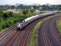 Around 715 AM on Canada Day, Via 6412 train number unknown , rounds the curve at Whitby east bound. With more Via trains having units at both ends and combining two trains, one has to wonder about the efficiency of a train like this. 11000 hp ? Can anybody shed a little knowledge on the EB?       