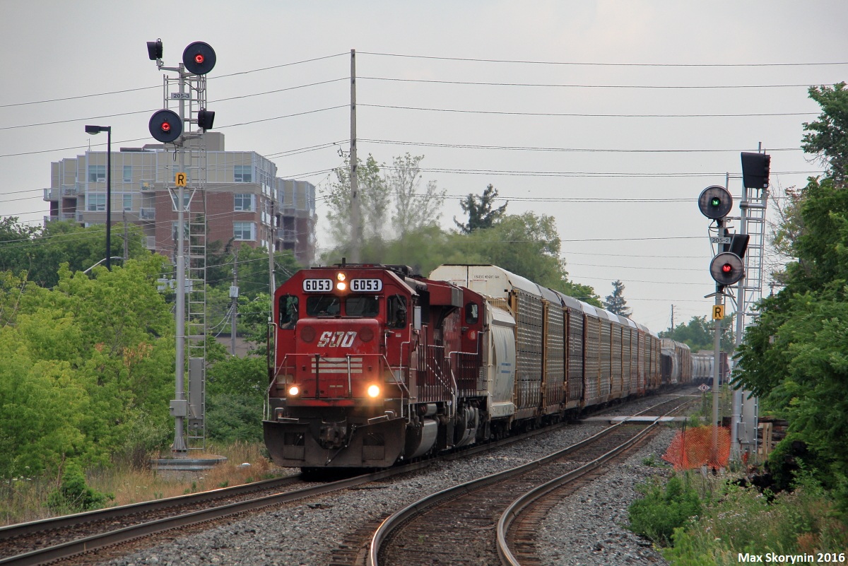 Canadian Pacific 242 has a legendary SOO Line SD60 leading still proud of its SOO paint as they fly into the small town of Streetsville, Ontario on their way to Toronto from the States.