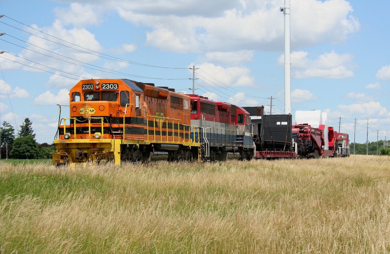 GEXR 516 shoves slowly eastward alongside Highway 7 just east of Guelph proving a fine display of its unusual load to long-weekend travelers on the adjacent main road.

I always wanted to try and shoot something on this open stretch but never got around to it when I lived in Guelph. As luck would have it, I was already visiting the area for the long weekend when I got tipped off about this move.
