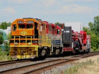 Having arrived at Georgetown, GEXR 516 with a special dimensional load from Babcox-Wilcox in Cambridge suns itself on the north track while waiting for a pair of other trains (CN 148 and GEXR 431) to slowly roll past with a 10 MPH restriction passing the dimensional car. After those two trains pass, the Goderich-Exeter power will uncouple and clear the junction at Silver, and the CN power that has just sitting there waiting for the last two hours just west of the junction will come in and couple on to the train and take over for the trip to Hamilton.