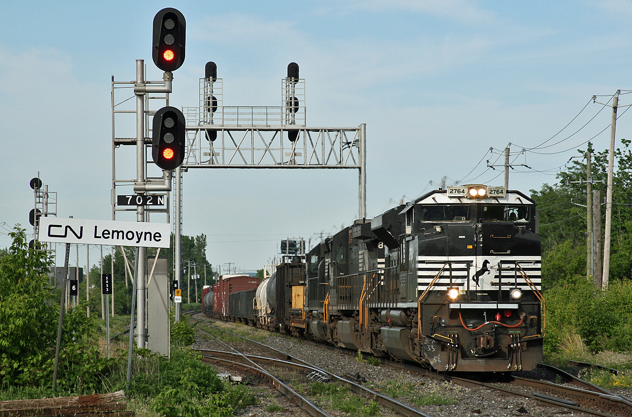 CN L 52921 18 has just cleared the Rouses Point Sub at Southwark and NS 2764, NS 8858 and NS 6137 already have their dynamic brakes wailing as they slow their 80 car train down for the Victoria Bridge.