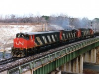 Decent looking westbound CN train captured crossing over the Highway 403 near Bayview. Power is CN 2110, 2033 and 2328; needless to say all long gone from the roster. Note the traffic visible down below. Nada.Zip. Probably just a break in the action but often I wonder where all todays' highway traffic is coming from. Geographically, I have always considered the CN wye here sort of in a no man's land, whether part of Hamilton, Burlington, or Flamborough is up to discussion, but I feel most comfortable identifying the area by the points of the wye....Bayview Jct., Hamilton West, or Hamilton Jct. as the points used to be known. The new ID "Snake" just doesn't cut it. (no offense to the 'Snake' who resides on this group)