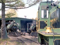 A view of the Pinafore Park Railroad's engine shed in St. Thomas in 1984. Pictured from left to right in the background are steam locomotives #2 (21-ton oil fired) and #1 (17-ton coal fired), both MLW 0-4-0T's originally built in 1926 for Canadian Gypsum. In the foreground is locomotive #3, a GE 25-ton diesel built in 1948. All were sold to the Huntsville & Lake of Bays Railway Society later in 1984, where #2 runs the Huntsville to Fairy Lake train and #1 is being restored.