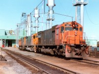 Back in the confines of the big sprawling iron ore complex at Port Cartier are seen a trio of MLW M-636s: Cartier 83, 73 and 45 at the locomotive servicing area. The 83 was scrapped 2011, 73 sold for scrap 2011, and the 45, which was x-CN 2304, was retired 2002 and sold. It currently lives as WNYP (Western NY and PA) #636.
 Cartier Railway is now known as ArcelorMittal Mines Canada.