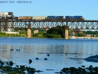 A matching pair of blue CEFX locomotives cross the Grand River at Galt.