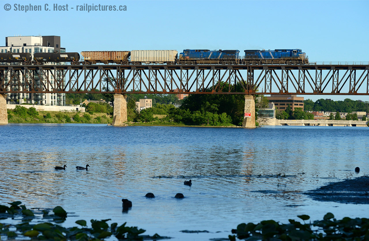 A matching pair of blue CEFX locomotives cross the Grand River at Galt.