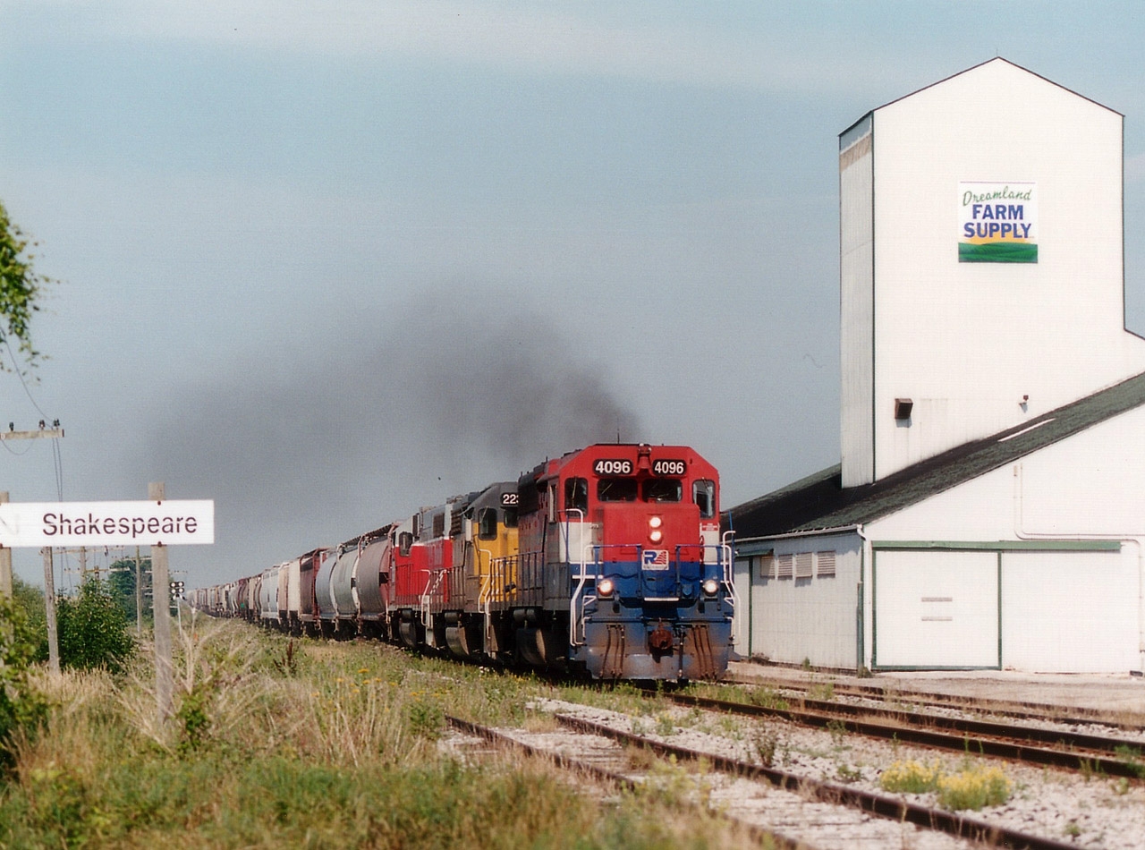 Eastbound morning GEXR train #432, with GEXR 4096, LLPX 2236 and RLK 3835 rolls past the feed mill complex at the S/W corner of the village of Shakespeare. This was a favourite location for me in years past.