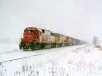 I suppose it is a bit odd to post a dead-of-winter type shot in the heat of summer. But for some people, such as myself, winter is an adventure. It sure beats sweating to death in the humidity of Summer Southern Ontario. The shiver season was getting late when this image was captured. It is already March. SOO 6025, UP 2947, CP 5909 and CEFX 3157 makes for a colourful photo, running at speed thru the snow at Mile 38 approaching Smithville. The symbol #388 denotes a grain train, and it is heading Stateside to the Port of Albany, NY. I've not seen a Grain Train thru here in quite a few years.