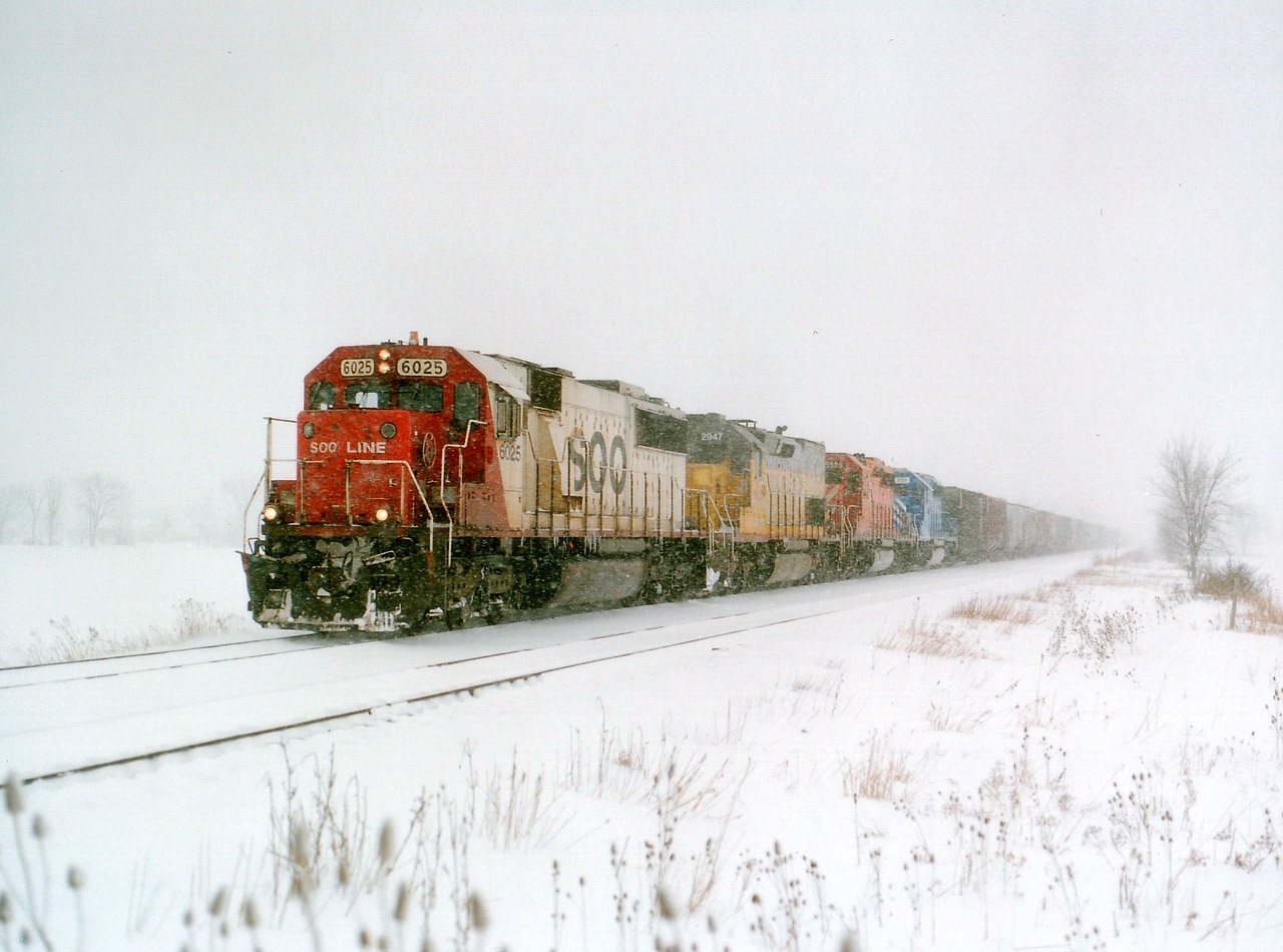 I suppose it is a bit odd to post a dead-of-winter type shot in the heat of summer. But for some people, such as myself, winter is an adventure. It sure beats sweating to death in the humidity of Summer Southern Ontario. The shiver season was getting late when this image was captured. It is already March. SOO 6025, UP 2947, CP 5909 and CEFX 3157 makes for a colourful photo, running at speed thru the snow at Mile 38 approaching Smithville. The symbol #388 denotes a grain train, and it is heading Stateside to the Port of Albany, NY. I've not seen a Grain Train thru here in quite a few years.