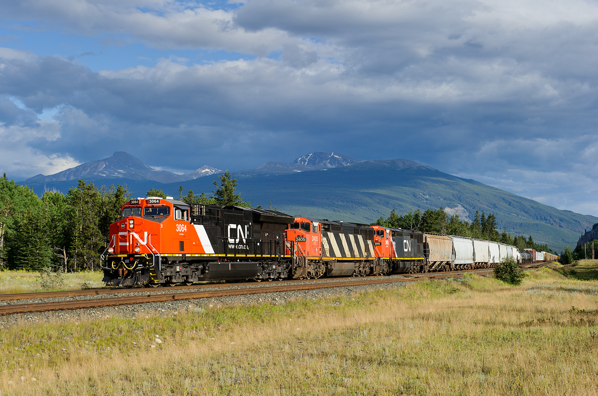 Brand new CN ET44AC 3064 teams up with C40-8Ms 2405 and 2415 passing Mile 229 of the Edson Sub with M302's train.