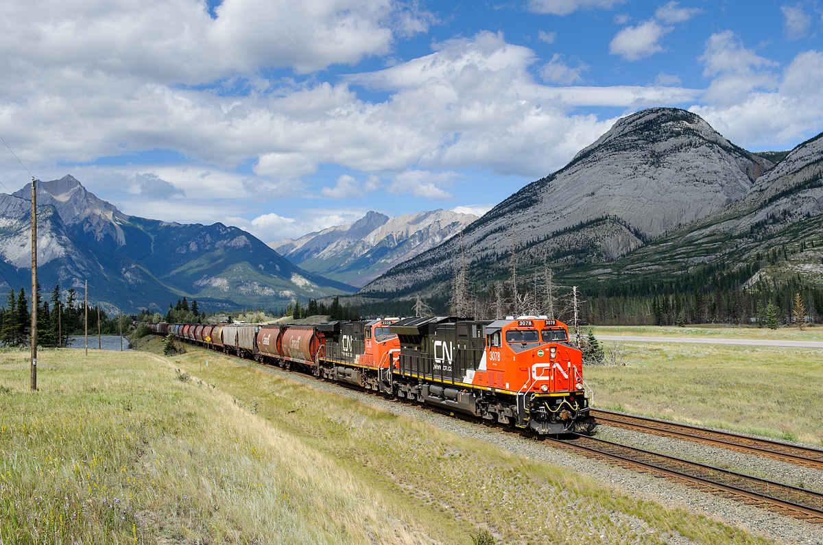Brand new CN ET44AC 3078 and ES44DC 2228 lead G84752-22's 193 loaded grain cars west on the Edson Sub at Henry House. Mid train were ES44DC 2279 and C40-8M 2439. The train weighed in at a whopping 25060 tons and was 11706' long.