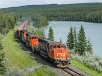 CN SD40-2Ws 5263, 5265 and 5298 hustle 84 Herzog ballast empties west on CN's Edson Sub, following the shores of the Athabasca River. The train is destined for another load from the pit at McAbee, BC