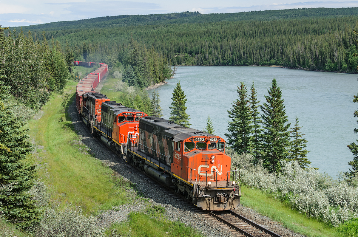CN SD40-2Ws 5263, 5265 and 5298 hustle 84 Herzog ballast empties west on CN's Edson Sub, following the shores of the Athabasca River. The train is destined for another load from the pit at McAbee, BC
