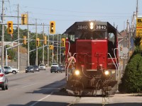 SOR's once a week train to serve the last customer on the Burford spur is seen polishing the rails in Clarence Street as the brakeman keeps a watchful eye on vehicular traffic. The Gp38 is unique in that it is one of only a few built with an extended cab allowing for a dual control stand.