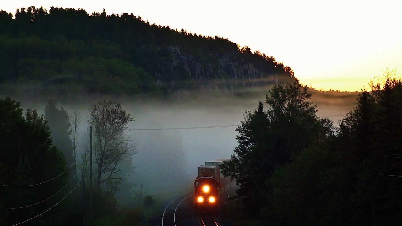 CN Q101 speeds out of a dense fog bank near Redditt, Ontario on a cool August morning.