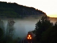 CN Q101 speeds out of a dense fog bank near Redditt, Ontario on a cool August morning. 
