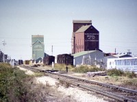 Now this is a unique part of Canada. I took a stab at location and road of this scene best I could, but it has been a long time. Lloydminster; probably the only city in North America that straddles two different jurisdictions.  Sure, there are examples like Kansas City, Kansas, and Kansas City, Missouri, but they are twin cities, whereas Lloydminster is the same city, but straddling two provinces. Where else could you see two grain elevators so close yet different provinces? Makes me wonder if either of them still exist. Along what I believe is the CN line, there is the station. What province is it in? I do not know. Need a Westerner familiar with the area to give us a rundown on just what is what. An interesting old photo though, and despite lack of a moving train, one of my favourite shots from bygone days. Years ago, most of the citizens lived on the Saskatchewan side, now 2/3 are on the Alberta side. AB charges only federal GST, SK also has a PST. To make it all fair, the whole city does not collect a PST within its limits.  Quite the place.