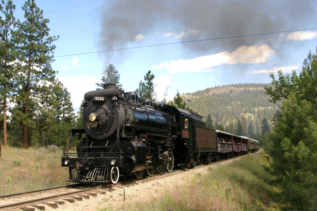 Kettle Valley Railway's excursion train powered by the spit & polished steam locomotive 3716 is seen returning up grade to the Prairie Valley Station at Summerland, BC after its two hour junket through Prairie Valley, its scenic vistas and open view of Okanagan Lake from high a-top Trout Creek trestle (238 feet above the canyon floor).