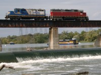 
Differing modes of transportation vehicles (2 of each) are captured at the Grand during a rare albeit timely encounter on a beautiful fall day ... providing a neat over and under shot per se.  Train Engineer and Boat Captain salute each other with repeated, friendly horn blasts to everyone's delight and to protect their respective rights of passage.  RLK 1808 and lead by stable-mate NECR 3840 are northbound over the Grand River at Caledonia enroute to the Stuart Street shop, Hamilton for maintenance.  Grand River 'Belle' and her first mate 'Princess' (in the distance) along with Queen (idle back at the launch) are part of a lunch and dinner venue for patrons to enjoy the tranquil beauty of the Grand River, its country like scenery and Grand River Cruise's hospitality, signature slow-cooked Ontario beef and low cal deserts.  