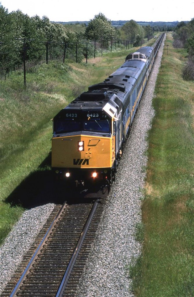 Although VIA had started receiving F40PH's in late 1986, they didn't really start showing up on the "Super Continental" until mid '88. This is likely due to them being used on the east coast trains where they replaced old MLW FPA-4's. Note that the second unit is an older covered wagon B unit. I don't think that the passenger cars were converted from steam at this time.