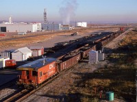 This Work Extra is backing down the Camrose Sub.
Esso's refinery complex is to the left. In the upper righ corner, Edmonton Power's power plant may be seen.
Note the speeder at left.
If you look really carefully, and us a little imagination, the Wainwright Sub bridge over the North Saskatchewan River may be seen slightly to the left and above the locomotives.